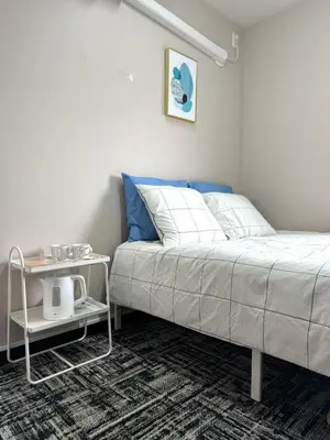 a bedroom with a bed and a side table at Nishisugamo hotel-TS0443 in Tokyo
