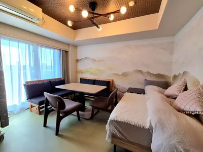 a room with two beds and a table and chairs at shibuya square 11F Shibuya Scramble Crossing near in Tokyo