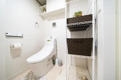 a bathroom with a toilet and a shelf at \uff48\uff44\uff43\u5927\u585a in Tokyo