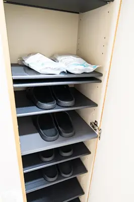 a closet with black shoes on the shelves at \uff48\uff44\uff43\u5927\u585a in Tokyo