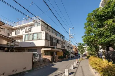 a white building on the side of a street at \u304b\u3064\u3089303 in Tokyo