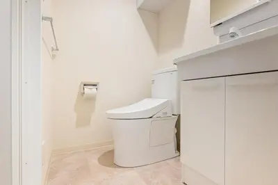a white bathroom with a toilet and a sink at \u304b\u3064\u3089303 in Tokyo