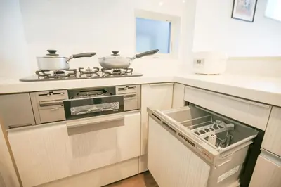 a kitchen with a stove with two pots and pans at SCD2 Ikebukuro Commercial District Premium Homestay in Tokyo
