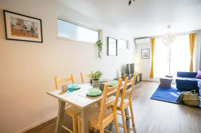 a dining room and living room with a table and chairs at SCD2 Ikebukuro Commercial District Premium Homestay in Tokyo