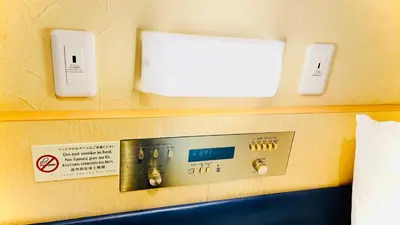a room with a control panel on the wall at \u30db\u30c6\u30eb\u30b5\u30fc\u30d6\u6e0b\u8c37 in Tokyo