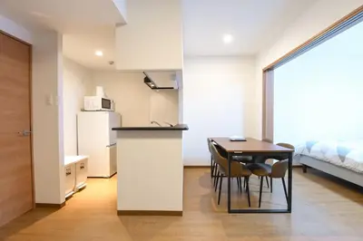 a kitchen and dining room with a table and chairs at Evergreen hotel ichigaya in Tokyo