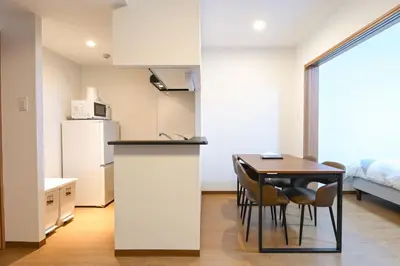 a kitchen and dining room with a table and chairs at Evergreen hotel ichigaya in Tokyo