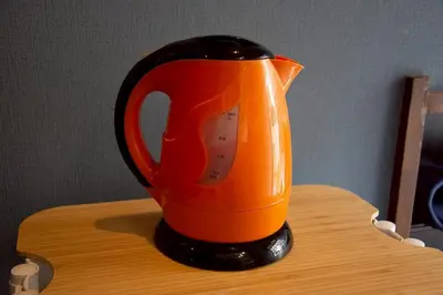 an orange and black pitcher sitting on a table at M&T stay in Tokyo