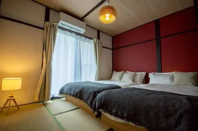 a bedroom with two beds and a window at M&T stay in Tokyo