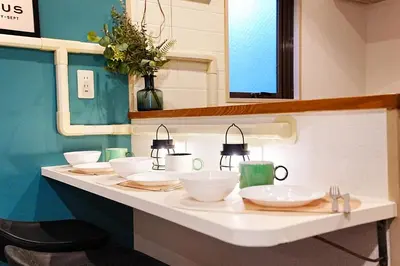a bathroom counter with bowls and lights on it at HIKA HOUSE Shinkoiwa in Tokyo