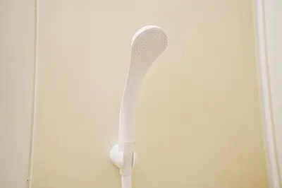 a white toothbrush is hanging on a wall at HIKA HOUSE Shinkoiwa in Tokyo