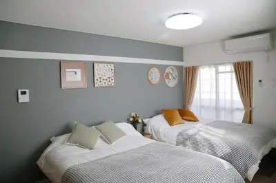 a bedroom with two beds and a window at Pr21 \u4e0b\u843d\u5408 in Tokyo