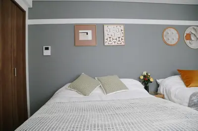 a bedroom with a white bed with two pillows at Pr21 \u4e0b\u843d\u5408 in Tokyo