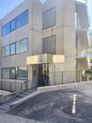 an empty parking lot in front of a building at STAY ARI Arakicho B in Tokyo