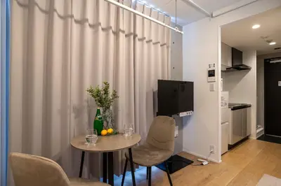 a room with a table and chairs and a curtain at \u30a2\u30fc\u30d9\u30a4\u30f3\u8981\u753a in Tokyo