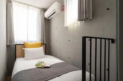 a bedroom with a bed with a book on it at \u30a2\u30fc\u30d9\u30a4\u30f3\u8981\u753a in Tokyo
