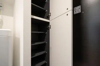 a closet with a white refrigerator and black shelves at \u30a2\u30fc\u30d9\u30a4\u30f3\u8981\u753a in Tokyo