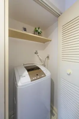 a small laundry room with a washer and dryer at Home Tokyo Takinogawa in Tokyo