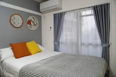 a bedroom with a bed and a window with at Pr22 \u4e0b\u843d\u5408 in Tokyo
