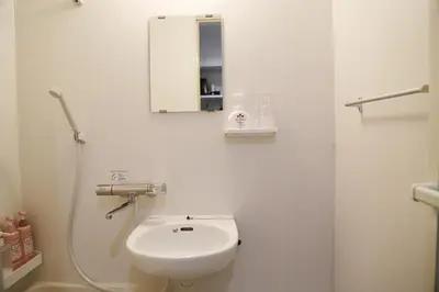 a white bathroom with a sink and a mirror at Pr22 \u4e0b\u843d\u5408 in Tokyo