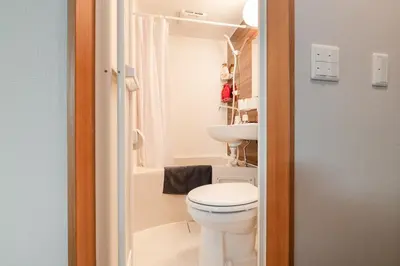 a small bathroom with a toilet and a sink at 7minute walk from JR Takadanobaba Station, 11 minutes from Shinjuku ,Wi-Fi, simple and high-quality space in Tokyo