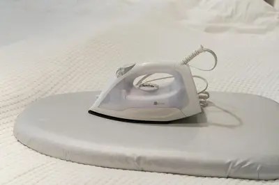 a white iron sitting on top of a bed at 7minute walk from JR Takadanobaba Station, 11 minutes from Shinjuku ,Wi-Fi, simple and high-quality space in Tokyo