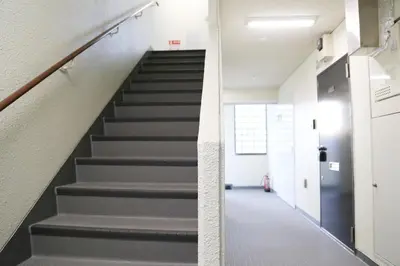 a staircase in an office building with gray stairs at Pr32 \u4e0b\u843d\u5408 in Tokyo
