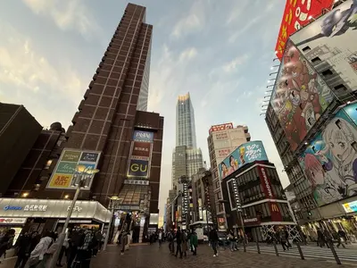 a busy city street with tall buildings and people at Pr32 \u4e0b\u843d\u5408 in Tokyo
