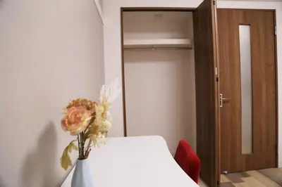 a vase with a flower on a table in a room at Pr33\u4e0b\u843d\u5408 in Tokyo