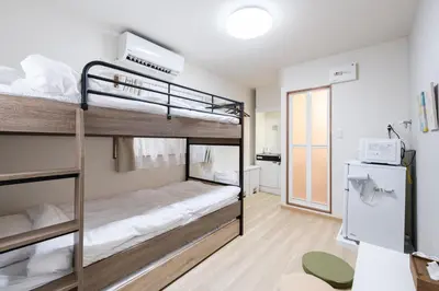 a room with two bunk beds in a building at Parkside Shinjuku Tokyo in Tokyo
