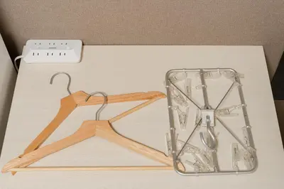 a wooden hanger with a glass container and scissors at Parkside Shinjuku Tokyo in Tokyo