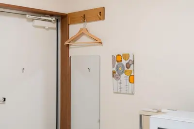 a room with a door with a hanger on the wall at Parkside Shinjuku Tokyo in Tokyo