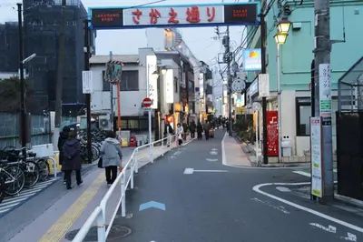 a city street with people walking down the street at Pr34\u4e0b\u843d\u5408 in Tokyo