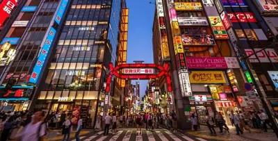 a busy city street at night with people crossing the street at Pr34\u4e0b\u843d\u5408 in Tokyo
