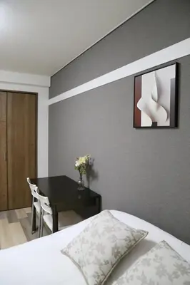 a bedroom with a desk and a bed and a table at Pr34\u4e0b\u843d\u5408 in Tokyo