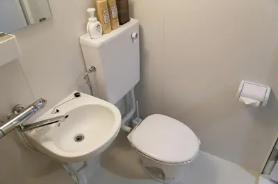a white bathroom with a toilet and a sink at Pr35\u4e0b\u843d\u5408 in Tokyo