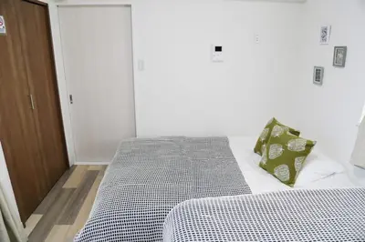 a bedroom with a bed with a black and white comforter at Pr36\u4e0b\u843d\u5408 in Tokyo