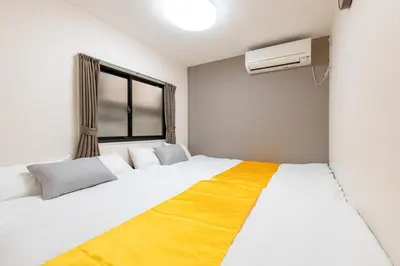 a bedroom with two beds and a window at ojima7 in Tokyo