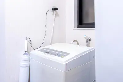 a white washer and dryer in a room at ojima7 in Tokyo