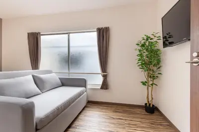 a living room with a couch and a window at ojima7 in Tokyo