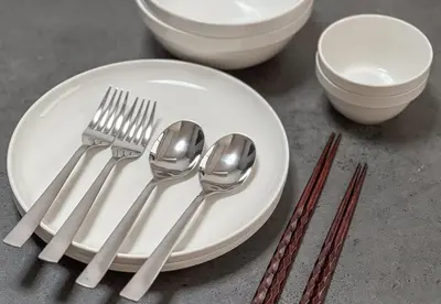 a white plate with forks and spoons on a table at ojima7 in Tokyo