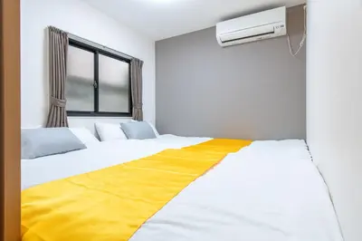 a bedroom with two beds and a window at ojima7 in Tokyo