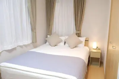 a bedroom with a white bed with two pillows at \u4e0a\u91ce \u79cb\u8449\u539f \u30a8\u30ea\u30a2 5LDK \u30c8\u30a4\u30ec3\u7b87\u6240 \u6d74\u5ba42\u7b87\u6240 \u30ad\u30c3\u30c1\u30f3 \u30c6\u30e9\u30b9\u3042\u308a\u8cb8\u5207\u4e00\u8ed2\u5bb6a in Tokyo