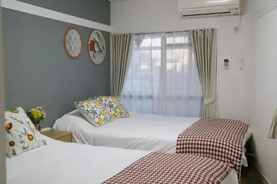 a room with two beds and a window with at Pr41\u4e0b\u843d\u5408 in Tokyo