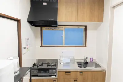 a kitchen with a stove and a sink at Miyabi in Tokyo