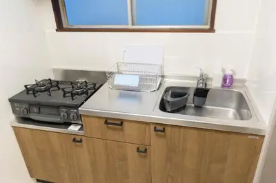a kitchen with a sink and a stove at Miyabi in Tokyo