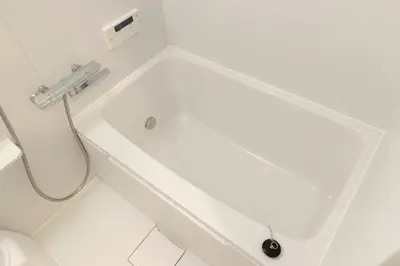 a white bath tub in a bathroom with a toilet at Miyabi in Tokyo