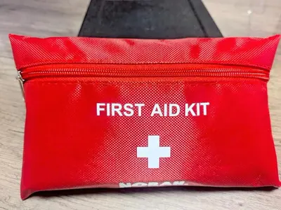 a red first aid kit with a white cross on it at Miyabi in Tokyo