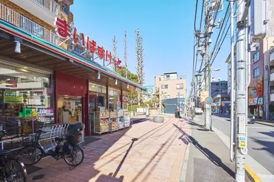 a street in a city with a bike parked on the sidewalk at \u30ec\u30b8\u30c7\u30a3\u30a2\u4e2d\u843d\u5408c in Tokyo
