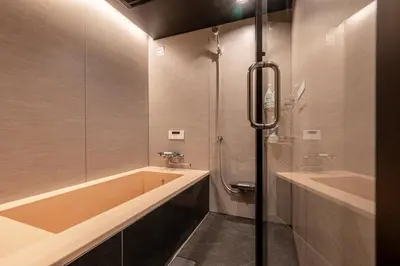 a bathroom with a tub and a sink and a shower at SEEK Tokyo in Wada